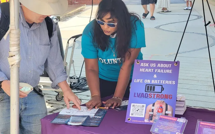 volunteer helping visitor at event