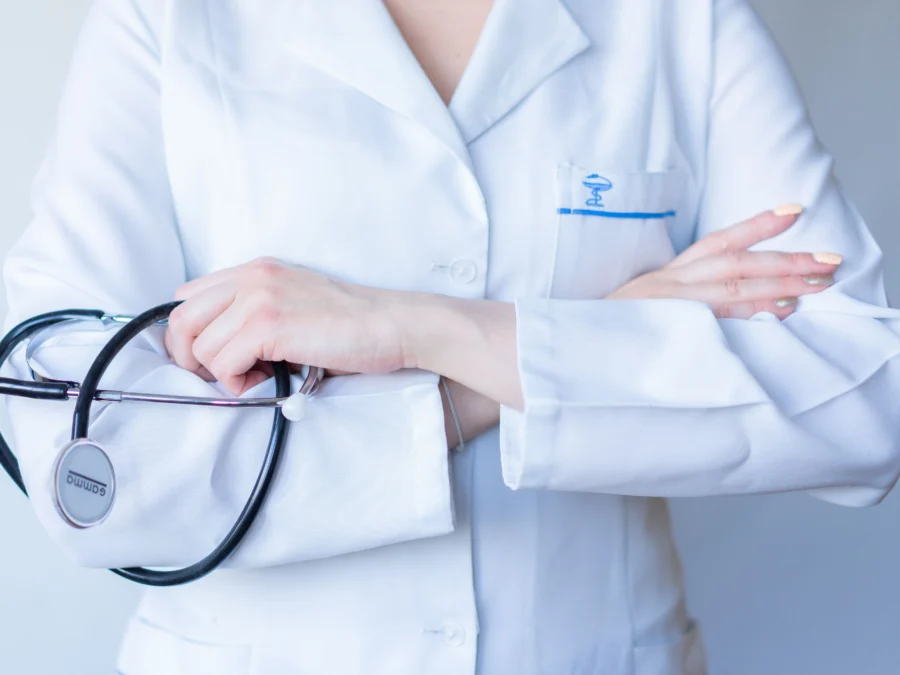 doctor holding stethoscope with arms crossed