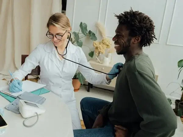 doctor using stethoscope on a patient